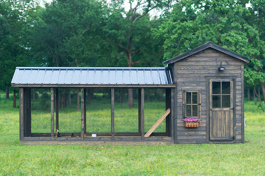 Exterior side view of a Yoderbilt Chicken Coop with gray stain.