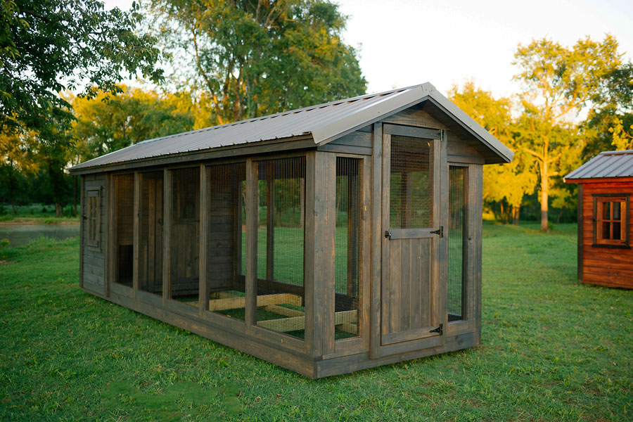 Side view of a Yoderbilt chicken coup with a single door and gray stain.