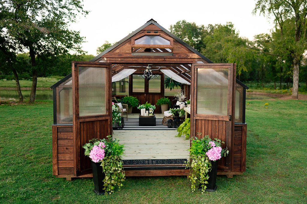 12x32 legacy greenhouse with brown stain and black metal trim - this greenhouse features front and back double doors