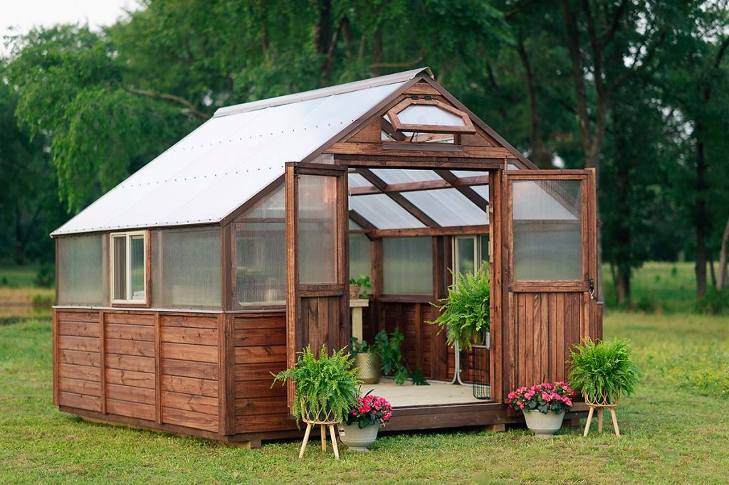12x12 legacy greenhouse with brown strain and brown metal trim - this greenhouse features a double door