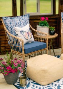 A chair with a butterfly pillow inside of a 12x16 Yoderbilt Greenhouse.