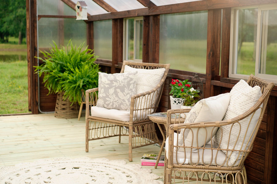 Two decorative chairs inside of a Yoderbilt Greenhouse.