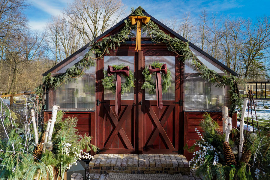 A Yoderbilt Greenhouse decorated in Christmas decorations.